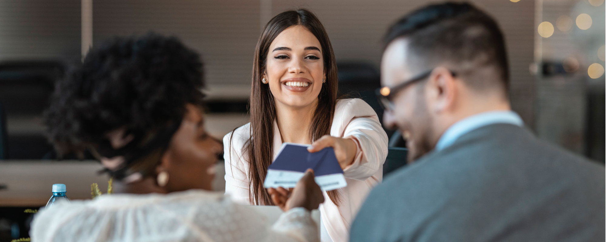 travel agent handing to tickets to her clients